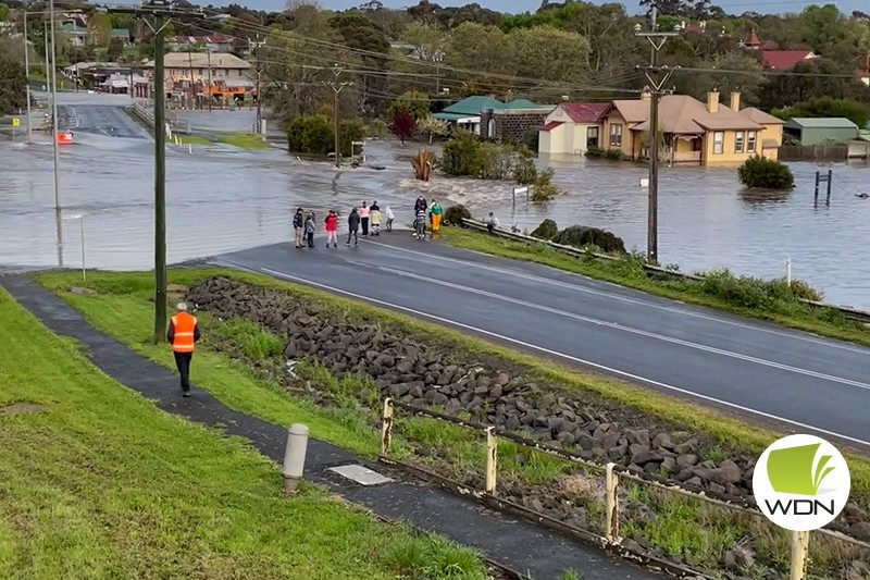 Working bee: Skipton businesses and homes were inundated with flood water on Saturday after heavy rainfall.