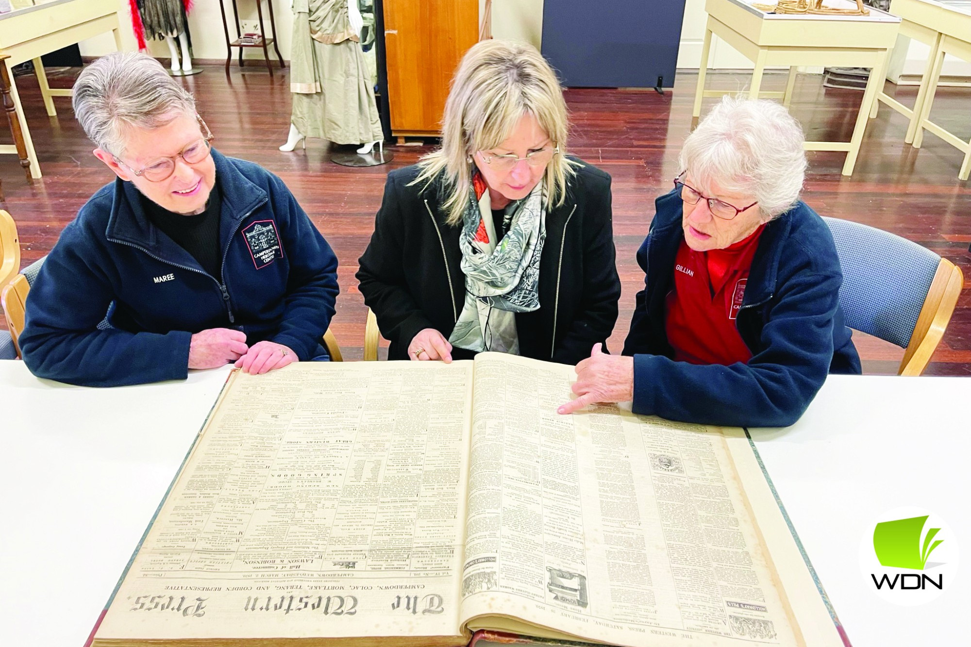 Camperdown and Historical Society members Maree Belyea (left) and Gillian Senior (right) show Member for Western Victoria Gayle Tierney through the society.