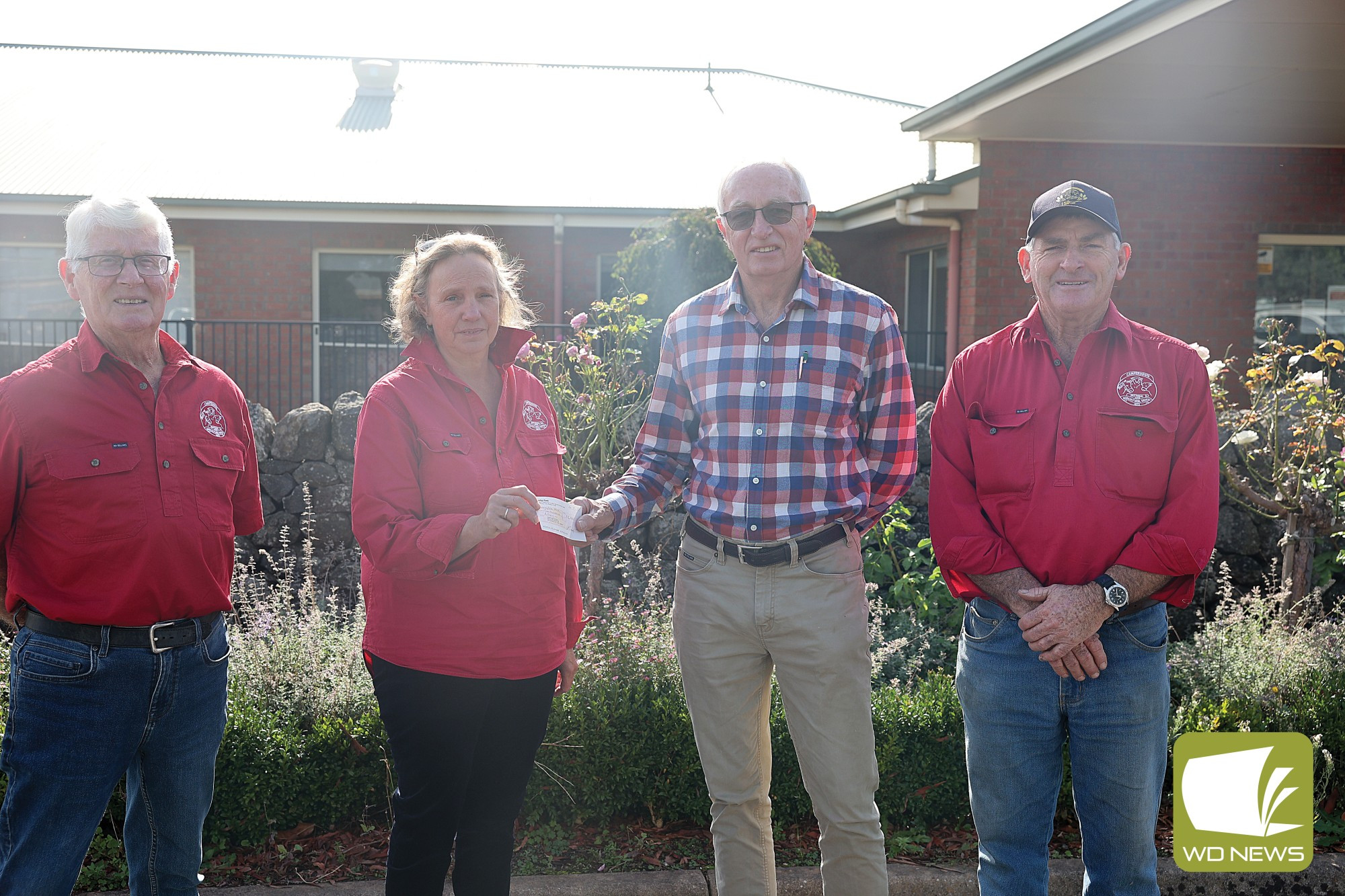 Giving back: Camperdown Pastoral and Agricultural Society president Cheryl McMahon, pictured with vice president Andy Riordon and committee member Bob Liddle, hands a cheque over to Sunnyside House chairman Philip Downine.