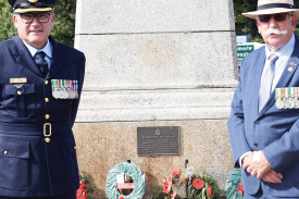 Lest We Forget: Group Captain Paul Murray (left) and RSL president Kevin Murray (right) with some of the wreaths laid by various community groups. 