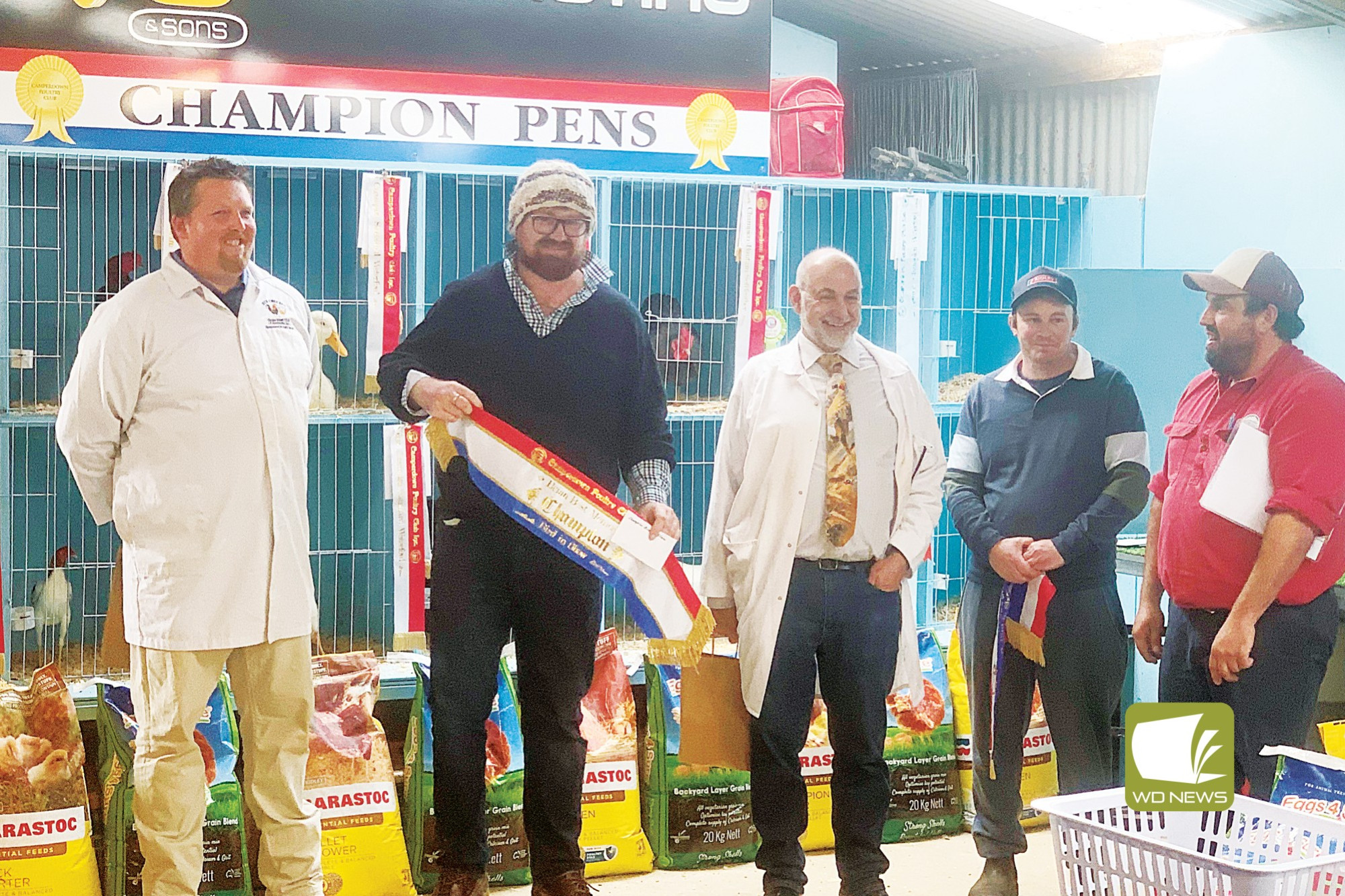 Clucking good times: Champion Bird in Show winner Mitch Carrigan-Walsh, with South Australian judges Michael Hall and Malcom Fuller, and Camperdown Poultry Club president Brenton Bishop.