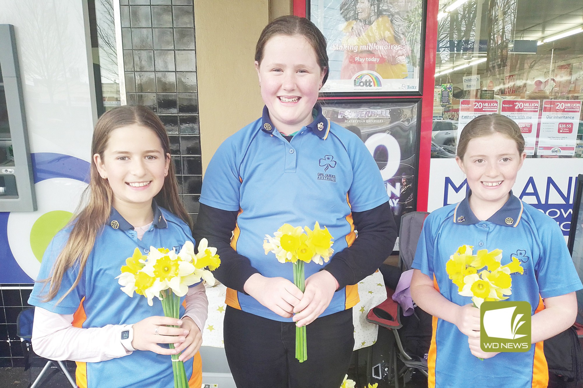 A colourful sale: Girl Guides Steph Fleming, Isla Spokes and Grace Barber sold donated daffodils in Manifold Street
