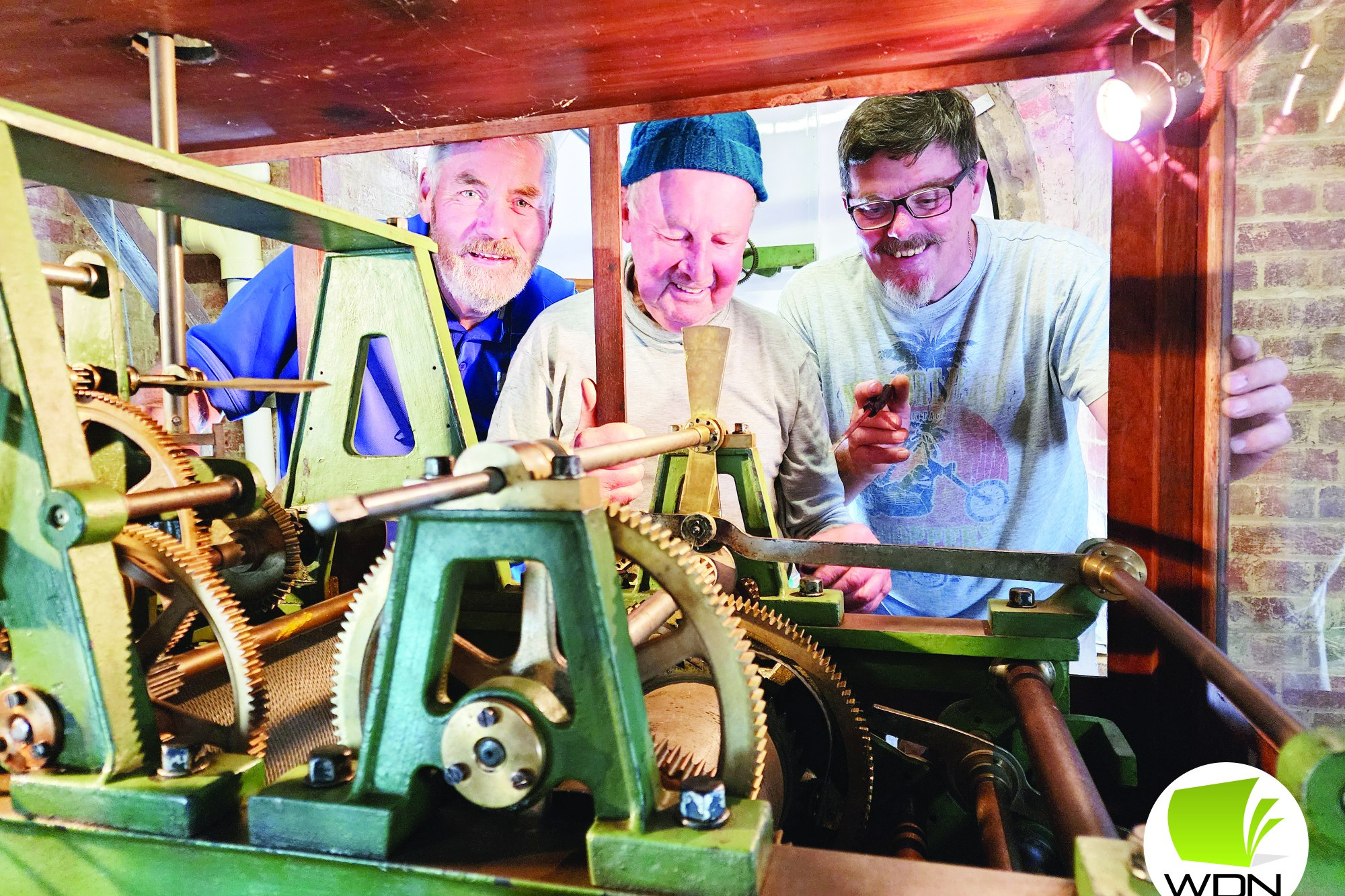 Works complete: Peter Fitzgerald, John Hulm and Peter Gstrein help complete the return of mechanisms to the Camperdown Clocktower after restoration works.