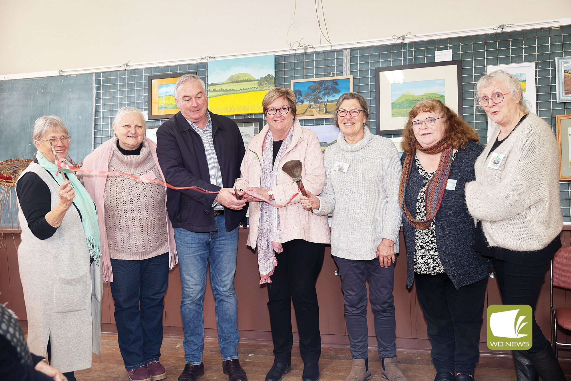Official opening: Corangamite shire councillors Ruth Gstrein and Laurie Hickey, with artists Joan Mahony, Lydia Green, Jan Barnes, Sue Hollingsworth and Isha Paasse, cut the ribbon to officially open the Corangamite Creatives exhibition.