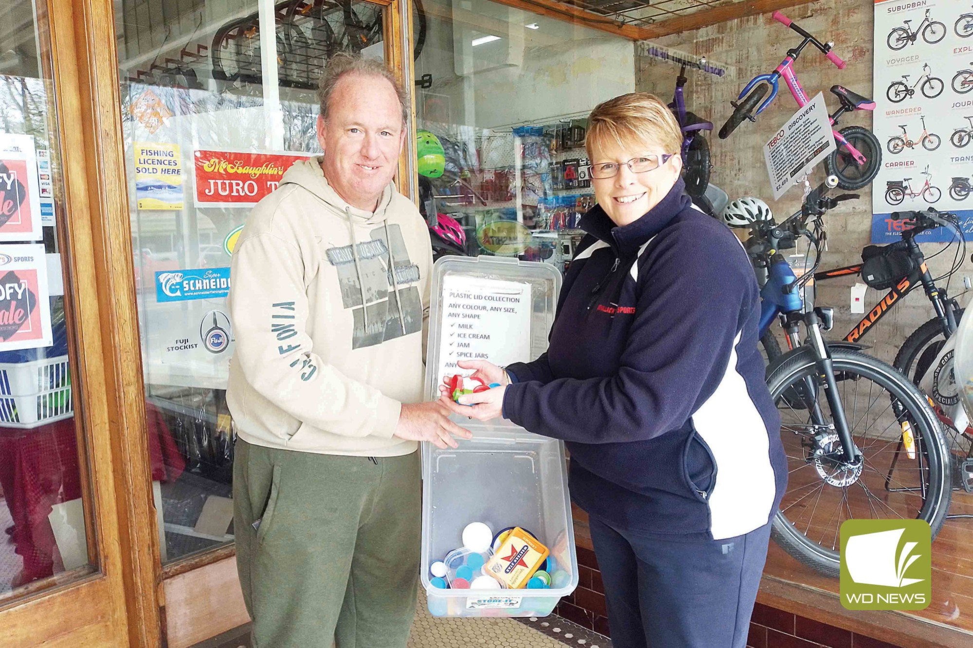 Working together: Bottle top collection organiser Peter James with Michelle Elijah at the Bellanack’s Sports collection point.