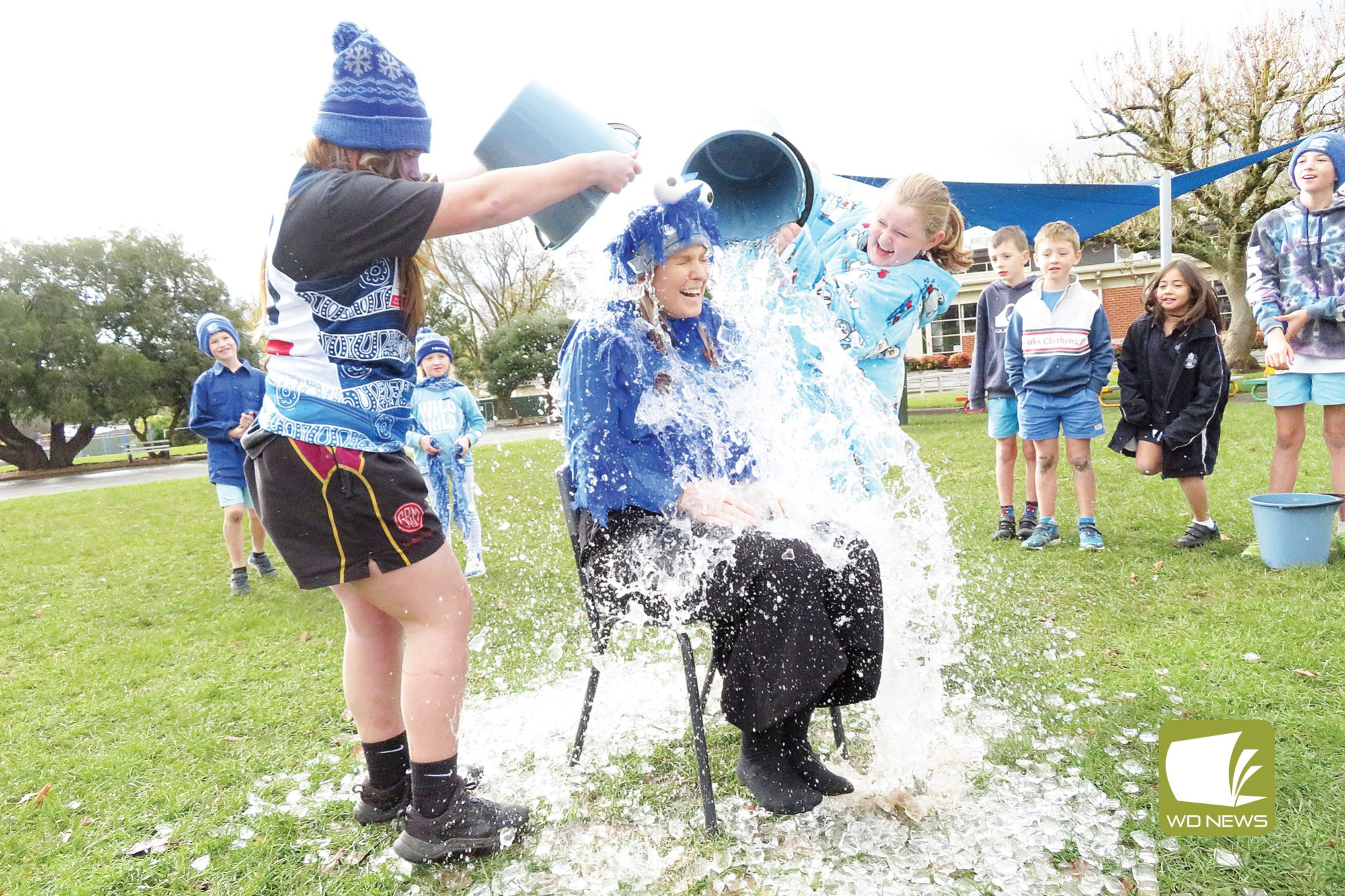 A chilly fundraiser: Camperdown College students marked their Blue day recently, dumping icy water over their teachers.