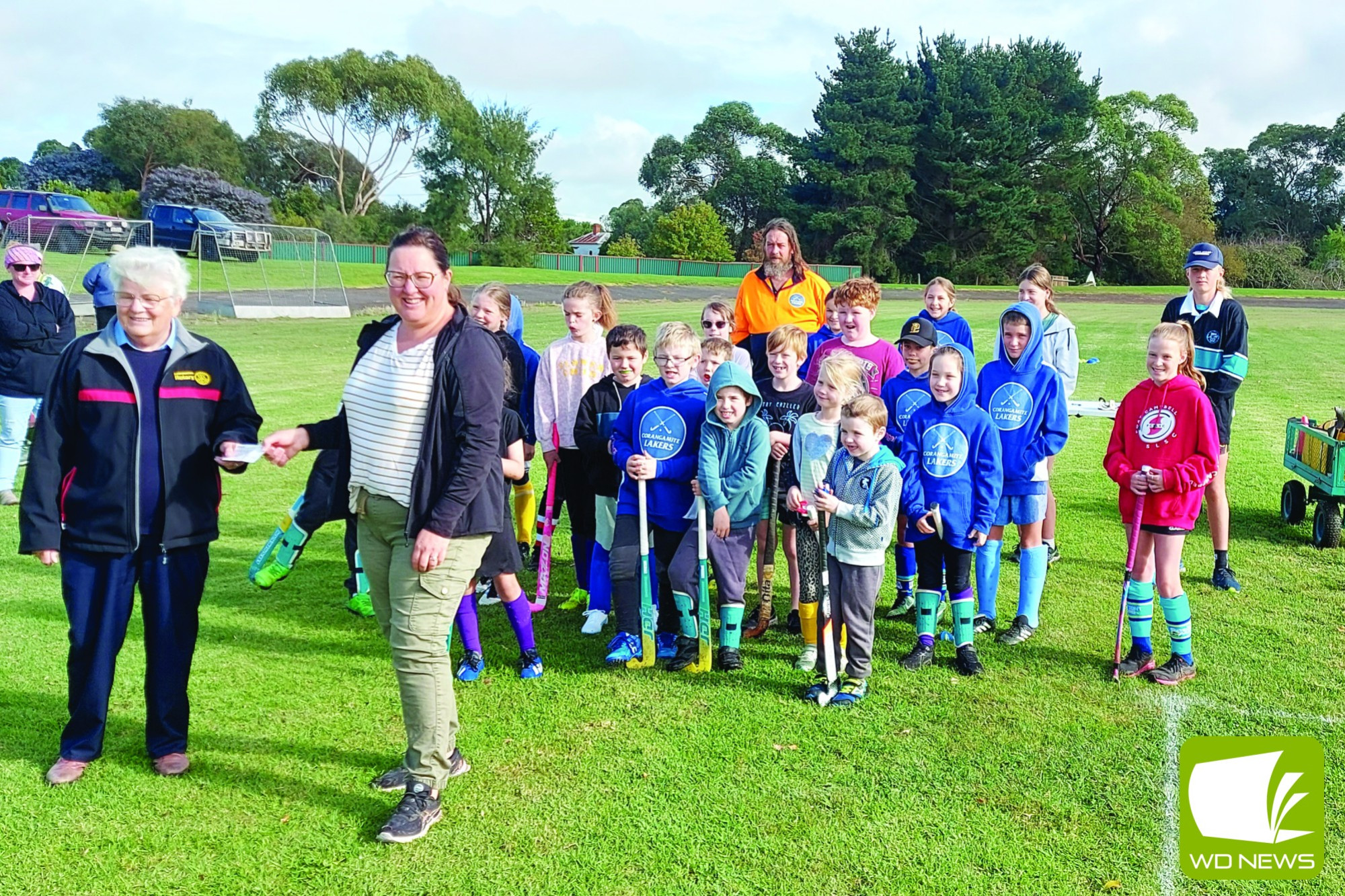 Pat Robertson and Kylie Spokes with Corangamite Hockey Club junior players and coaches.