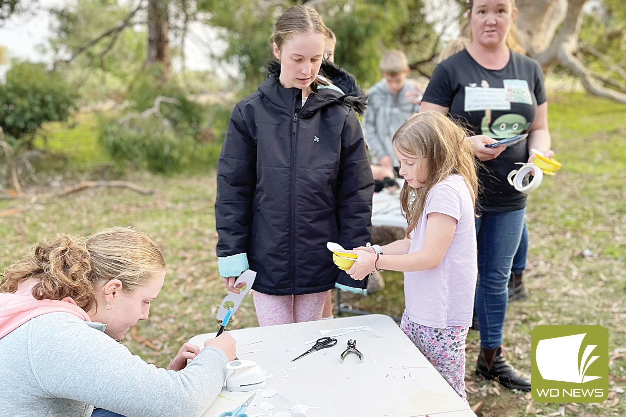 Out in nature: Brigette Mulcahy, Grace Barr and Eve Barr enjoy a nature play workshop run by Tania Maloney at the annual Night Stalk.