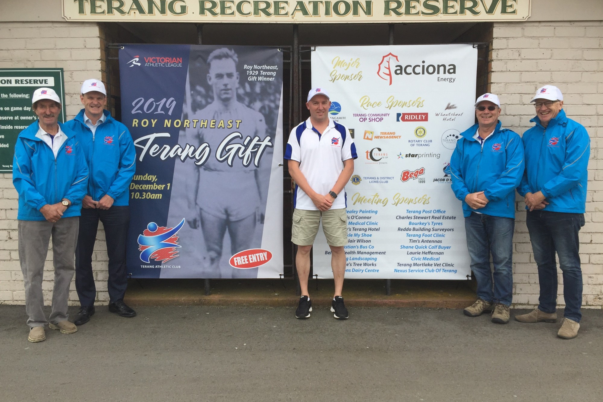 Terang Athletic Club committee members (l-r) Laurie Heffernan, Brendan Williams, Jacob Densley, Ken Plummer and Kerrin McKenzie in front a banner Densley made commemorating Roy Northeast.