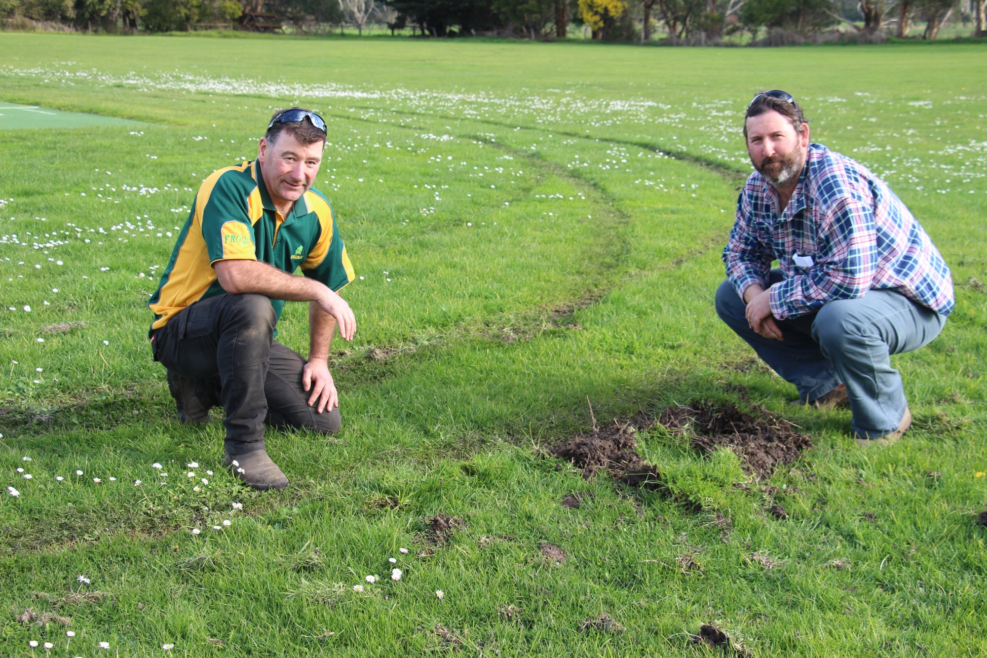 Frustrated: Ecklin Cricket Club officials Lance Finney (left) and Kevin Wines survey the damage at the club’s ground following a hoon’s decision to complete circle work on the surface.