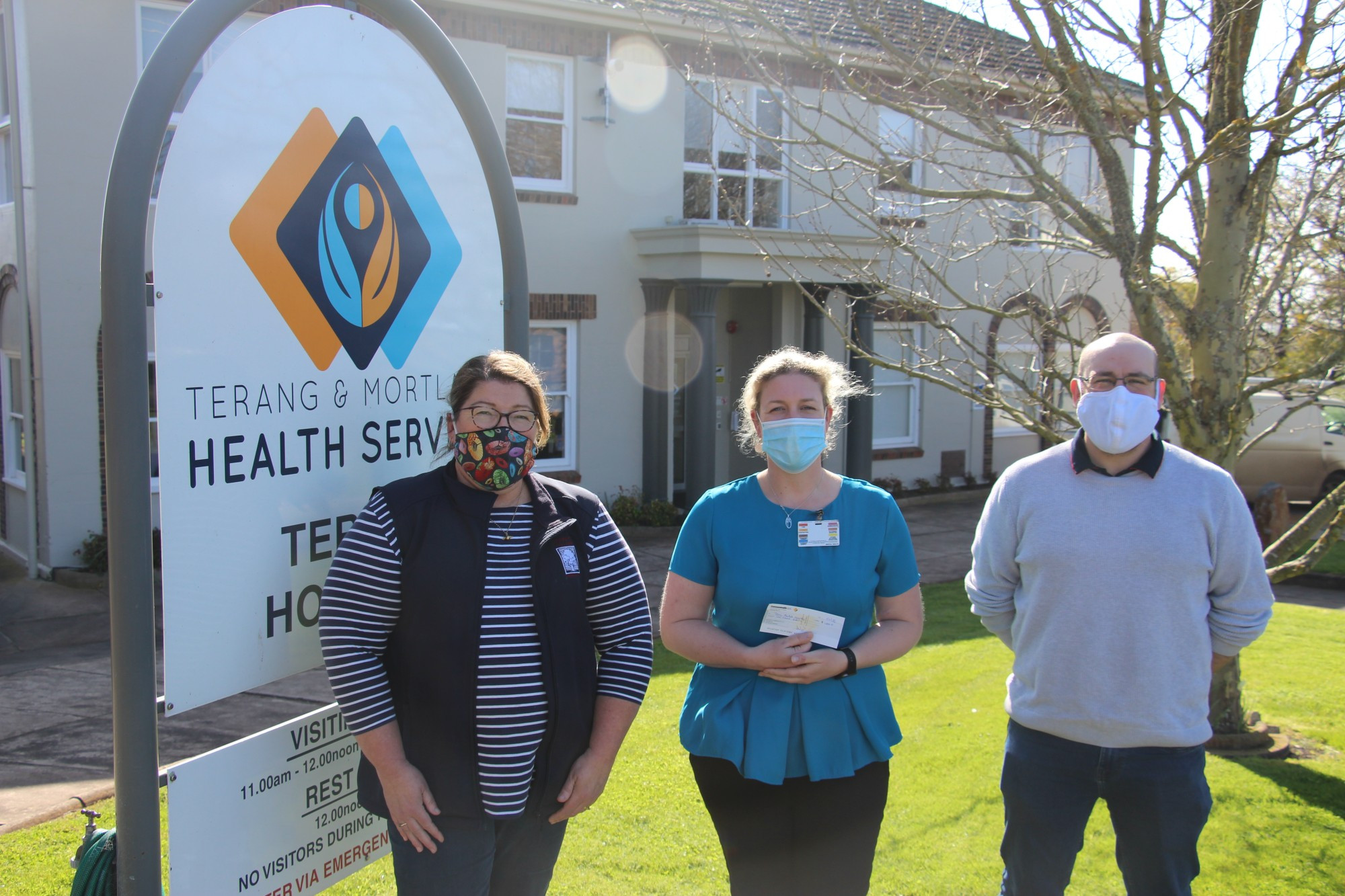 Donation: Terang College teacher Narelle Holliday (left) and Terang Progress Association president Ben Dennis present Terang Mortlake Health Service chief executive officer Julia Ogdin with a $1000 cheque donated to the health service as part of the recent mask making campaign in Terang.