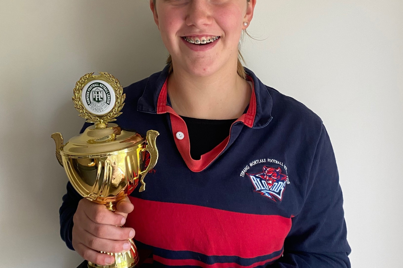 Alice Suhan shows off her new silverware after she took out the Hampden Football Netball League’s 15 and under netball best and fairest with Cobden’s Matilda Darcy on Saturday.