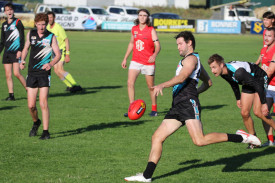 Jason Moloney drives the ball forward for the Power. 