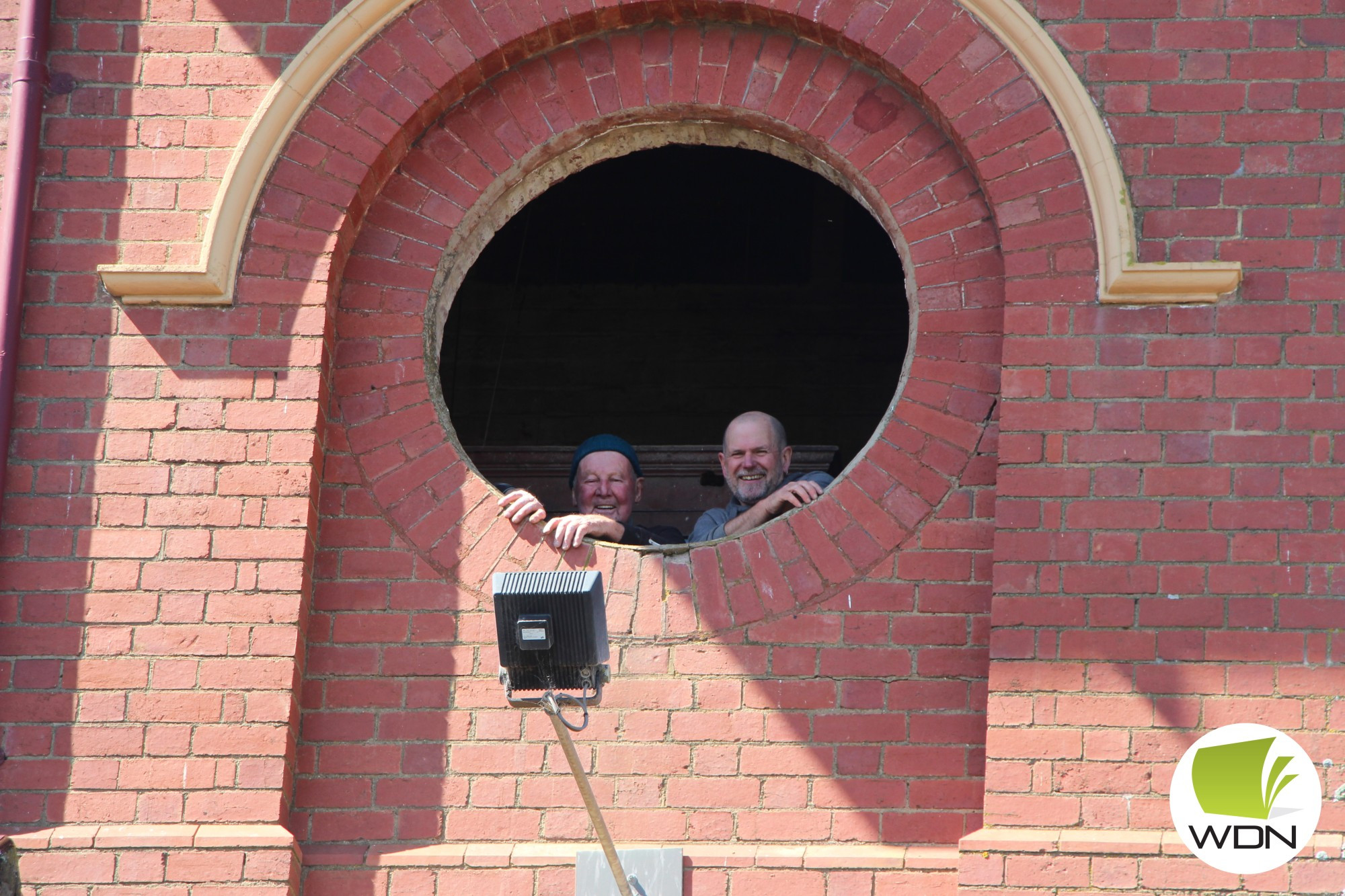 Right on time: Ian Currell (right) of Currell Signs and John Hulm began work to restore the clock faces of the Terang Post Office clock tower over the weekend.