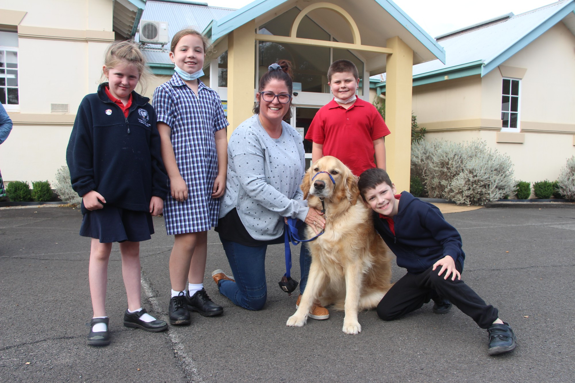 Good boy: Terang College and Hampden Specialist School students Monica Tokana, Zoe Symons, Roarke Cust and Wyatt Mcintosh, pictured with teacher Leah Boyd, gathered to welcome therapy dog Cooper this week.