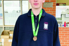 Bailey Dennis with his bronze medal.