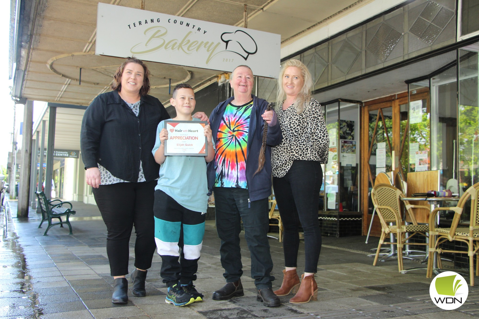 Personal donation: Anna McMaster (left) and Julia Bettess (right) from Terang Style Studio gave Elijah Quick and Sue Kull a close shave in the name of charity last week.