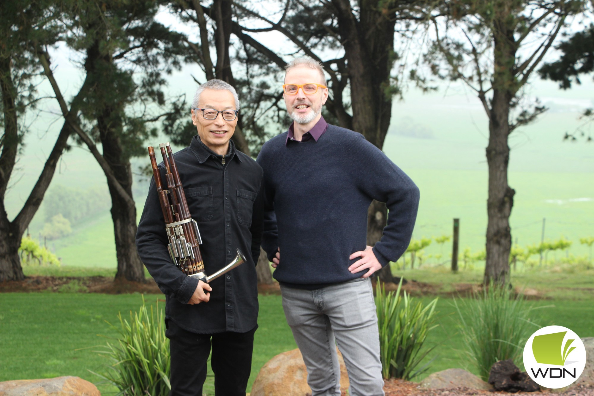 Breaking bread: Lismore-based artist Xan Coleman (right), pictured with Chinese-Australian musician Wang Zheng-Ting, have brought an evening of food, music and connection to Keayang Maar Vineyard.