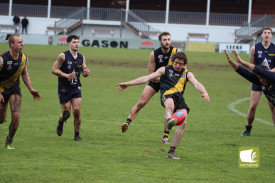 Simon Atkinson gets a quick kick in under pressure. 