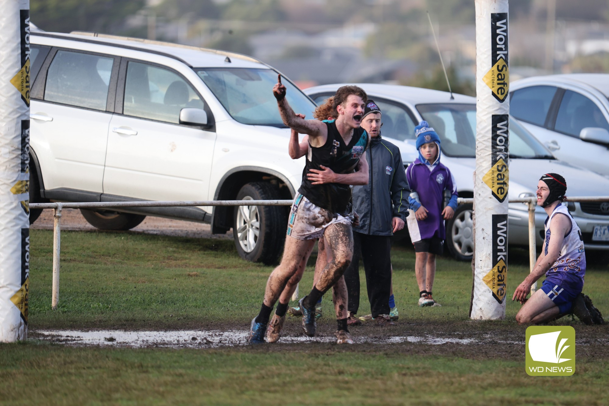 Ed Lee celebrates in the wet conditions against Russells Creek last weekend.