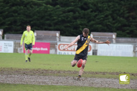 Liam Cameron kicks strong in the mud. 