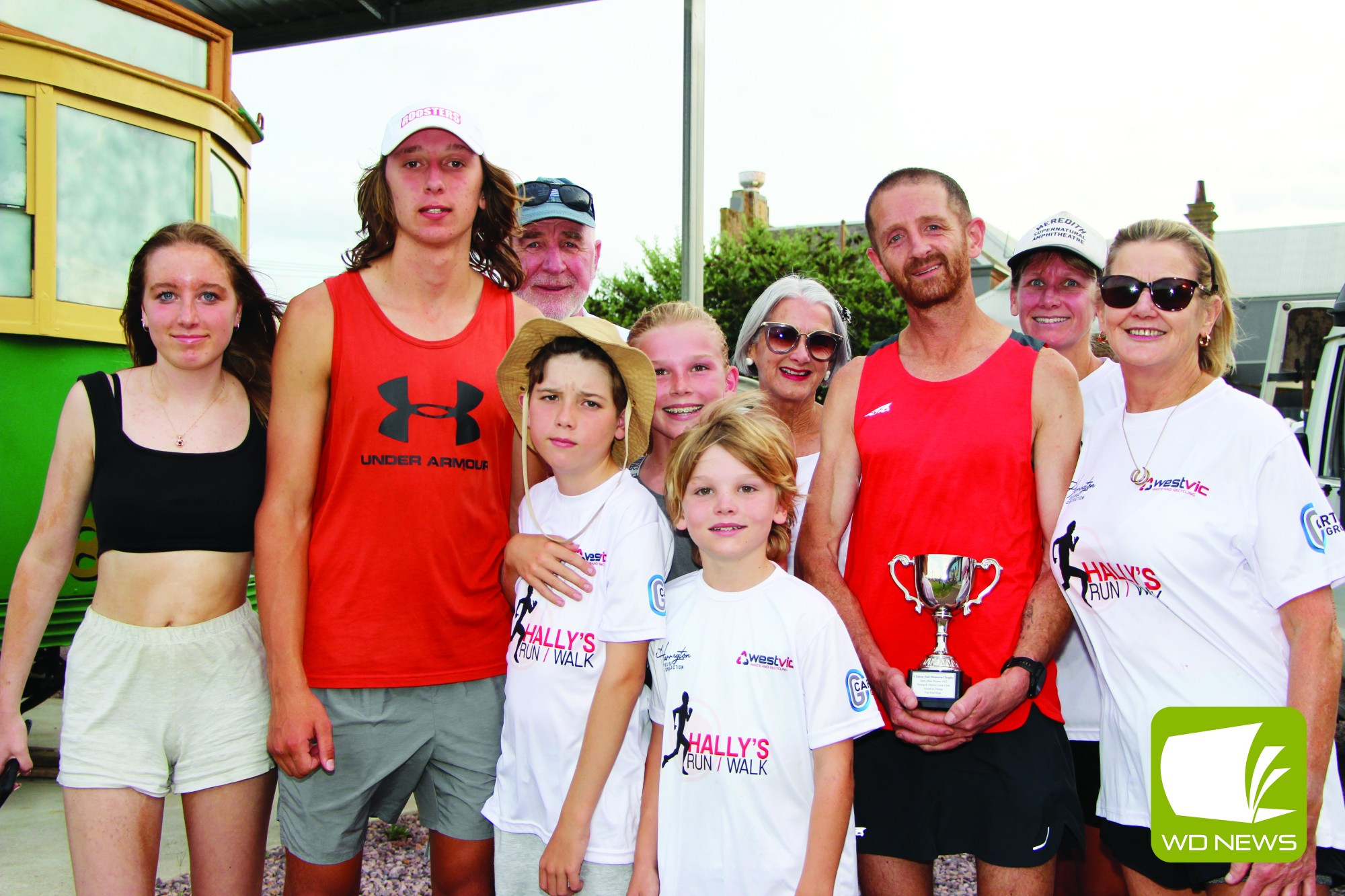 The family of Warrnambool athletics stalwart Clinton Hall, pictured with overall winner Ben Wallis (third from right) holding the trophy named in Hall’s memory.