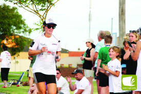 Clinton Hall’s sister, Nadia, gets some encouragement as she closes in on the finish line. 