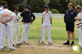 Mortlake players discuss the surface. 