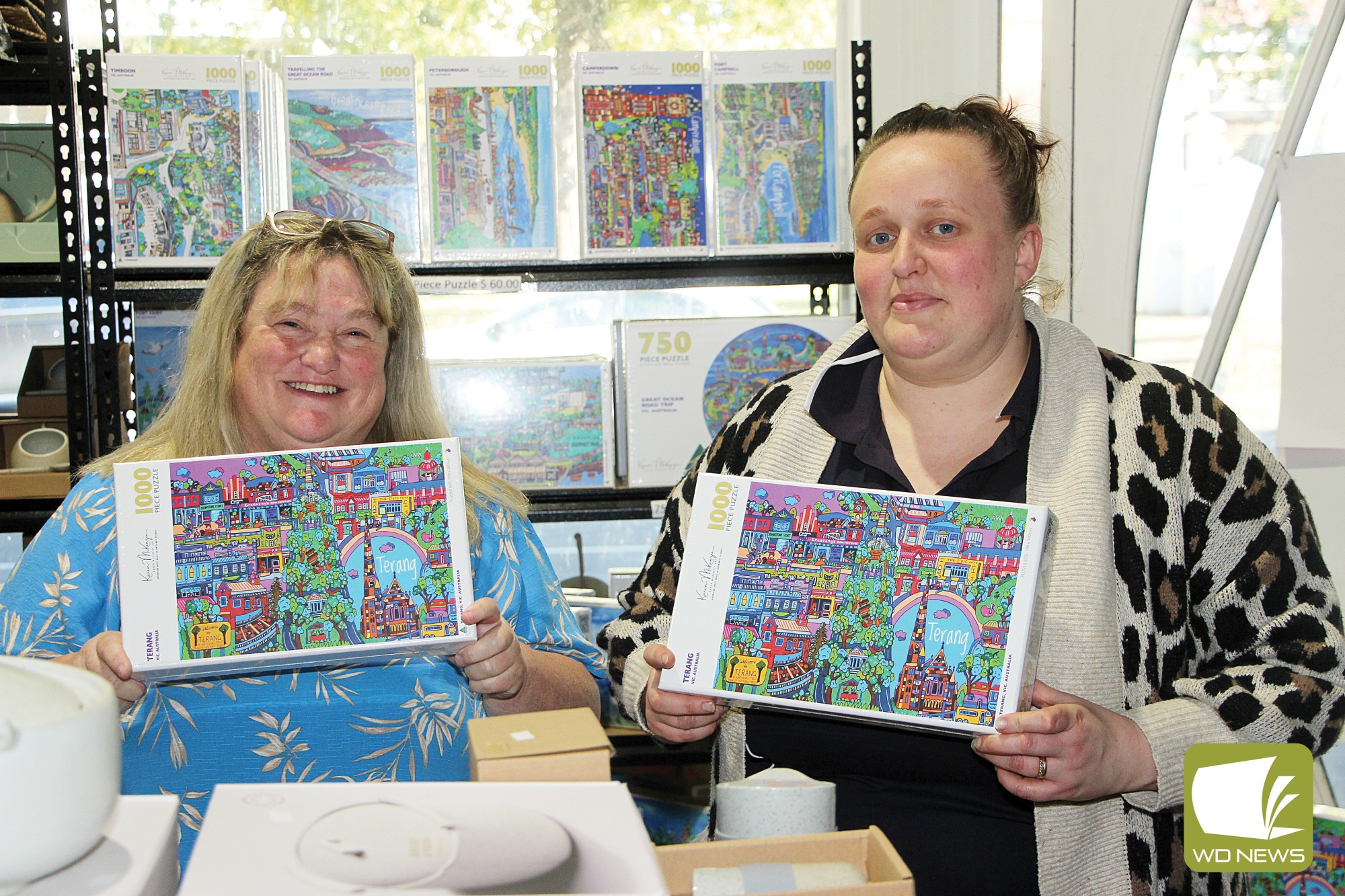The missing piece: Mailors Flat artist Karen McKenzie delivered the first batch of puzzles, which depict Terang, to Greavesys Fruit n Veg owner Cassie Greaves last week.