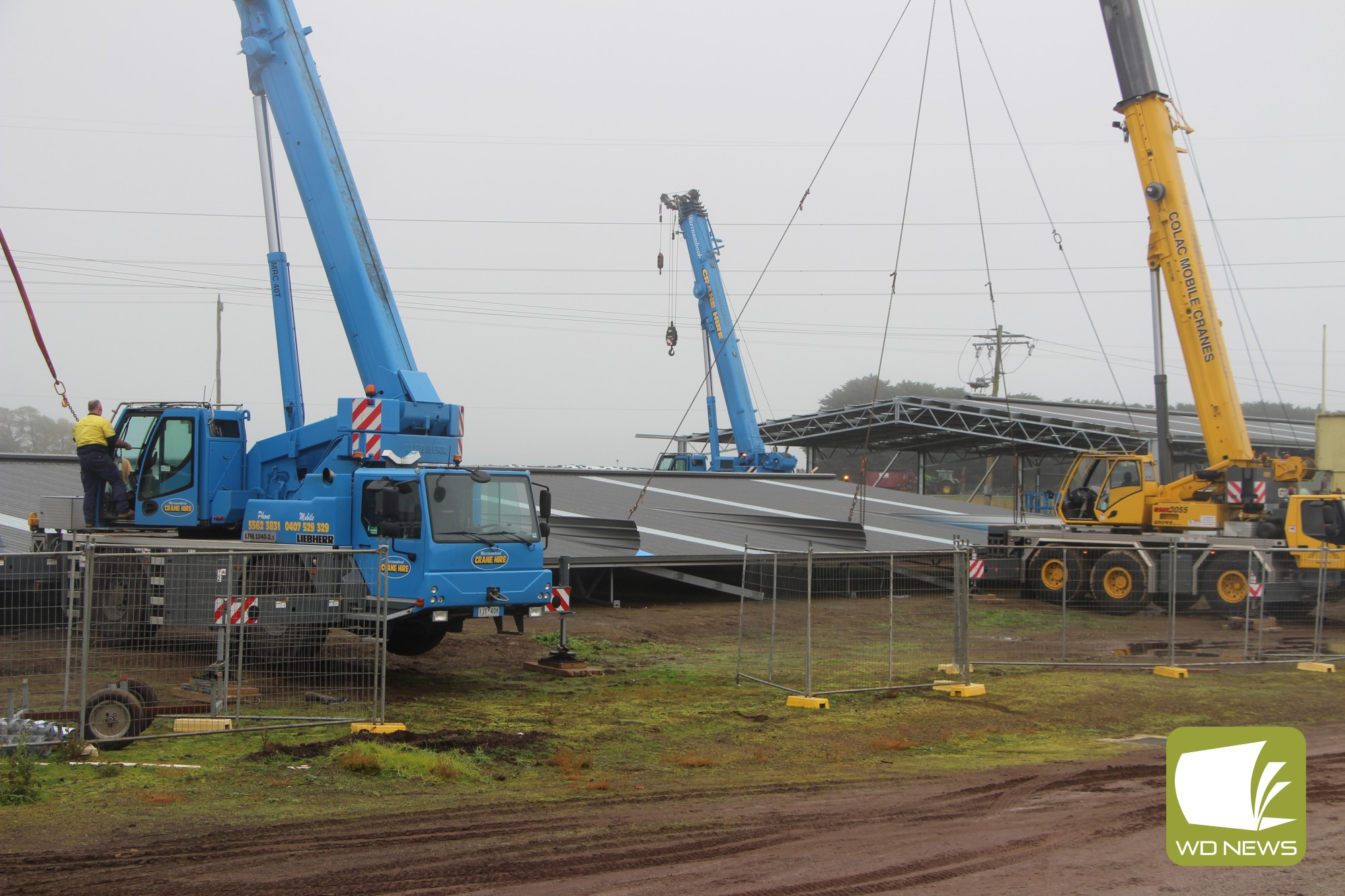 Going up: It took four cranes and a dedicated team of workers to lift the next phase of Terang Harness Racing Club’s $1.7 million upgrades in to place at Dalvui Racecourse last Friday.