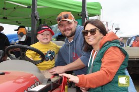 Charles Munnis, 2, pictured with David Munnis and Sarah Gartlan, showcased his tractor driving skills. 