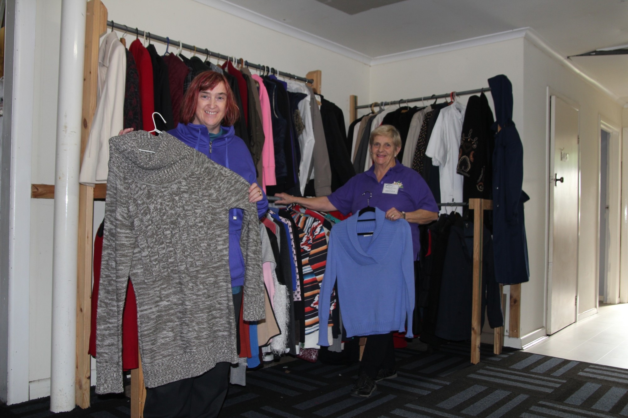 Doors open: Timboon Opportunity Shop (TOPS) volunteers Jasmine McBain and Brenda Parfett look forward to welcoming locals needing essential items into the shop.