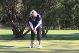 Janine Stevens watches her putt on the seventh green. 