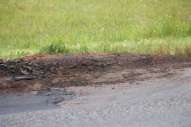 This pothole is too large to avoid with oncoming traffic. 