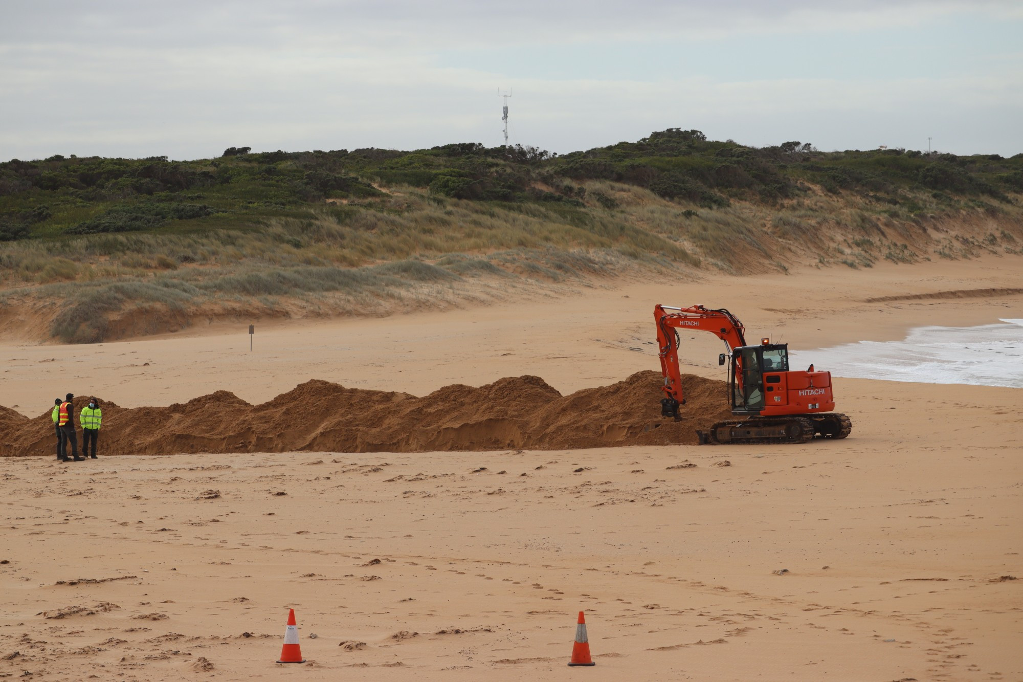 Success: Contractors moved in to artificially open the river mouth at Peterborough on Friday.