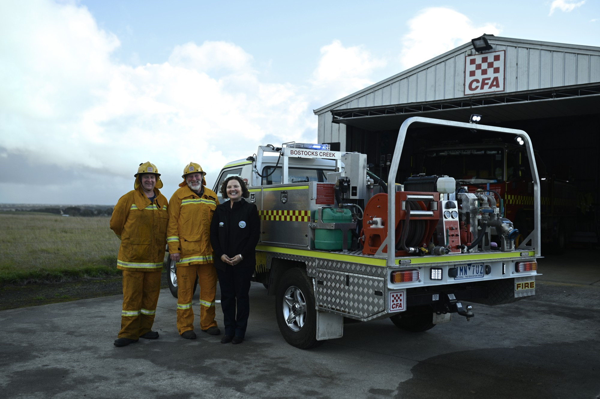 Working together: Bostocks Creek CFA members Richard Downs and John Fallon thank Fonterra represnetative Jozzy Bevin for their support.