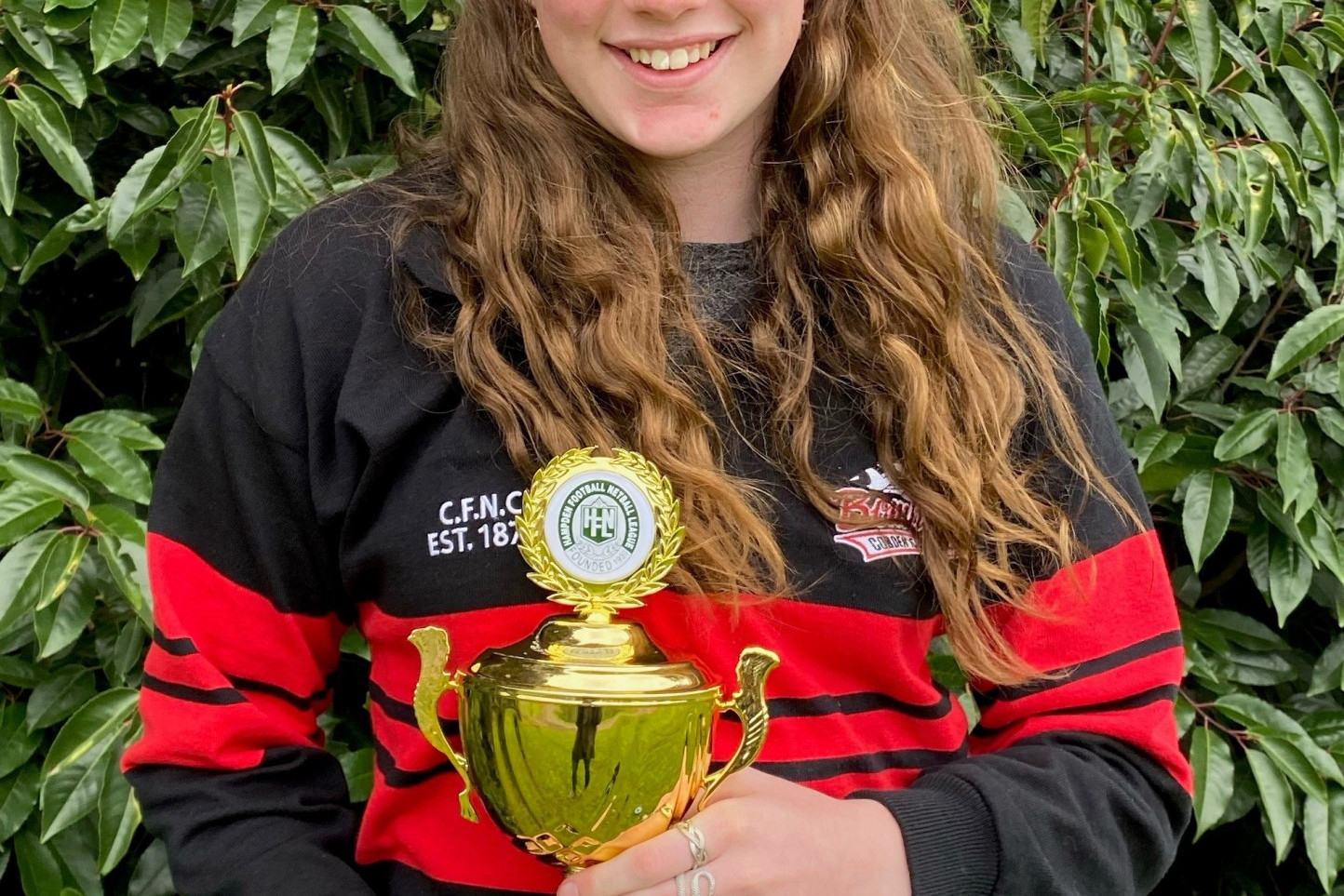 Matilda Darcy shows off her new silverware after she took out the Hampden Football Netball League’s 15 and under netball best and fairest with Terang Mortlake’s Alice Suhan on Saturday.