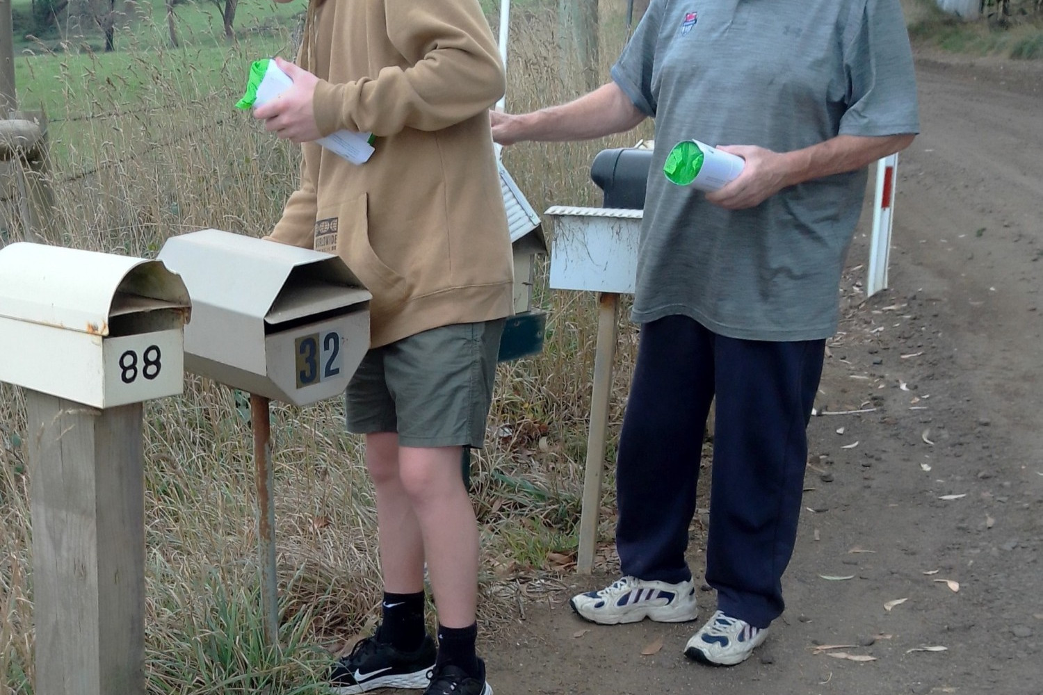 Left: Timboon Lions Club member Mike Herrin with his grandson Darcy Croft delivering Corangamite Shire tidy bags to Timboon mail boxes.