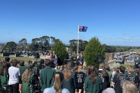 Carmel Cranage, Reinier Bouman and Liz Formby sing the Australian national anthem. 