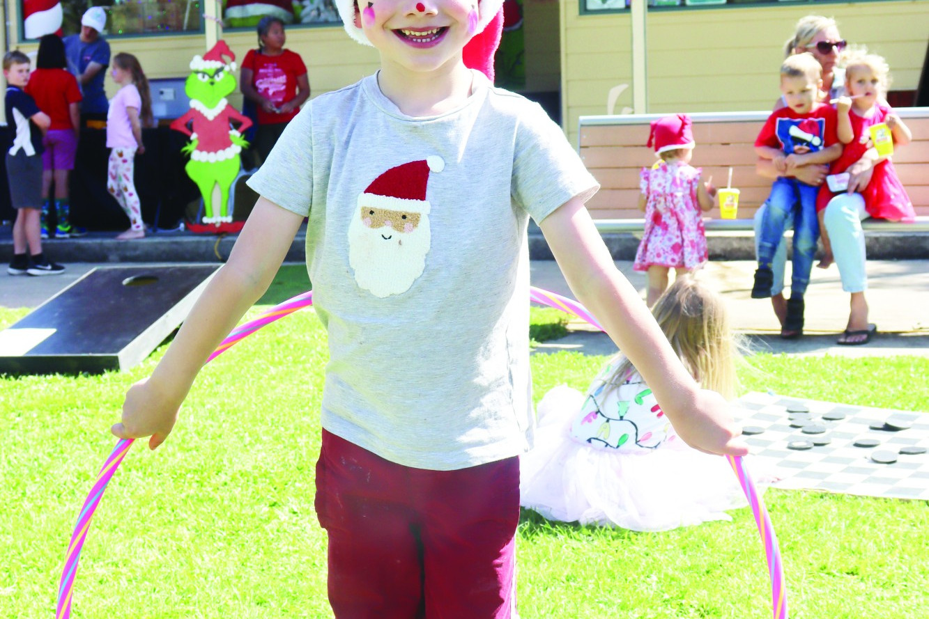 Merry Christmas: Young Ethan Cotton, 5, enjoys all of the fun and games on offer at Timboon’s Christmas celebrations.