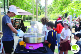 Youngsters line up for fairy floss at Timboon’s Christmas celebrations on Friday. 