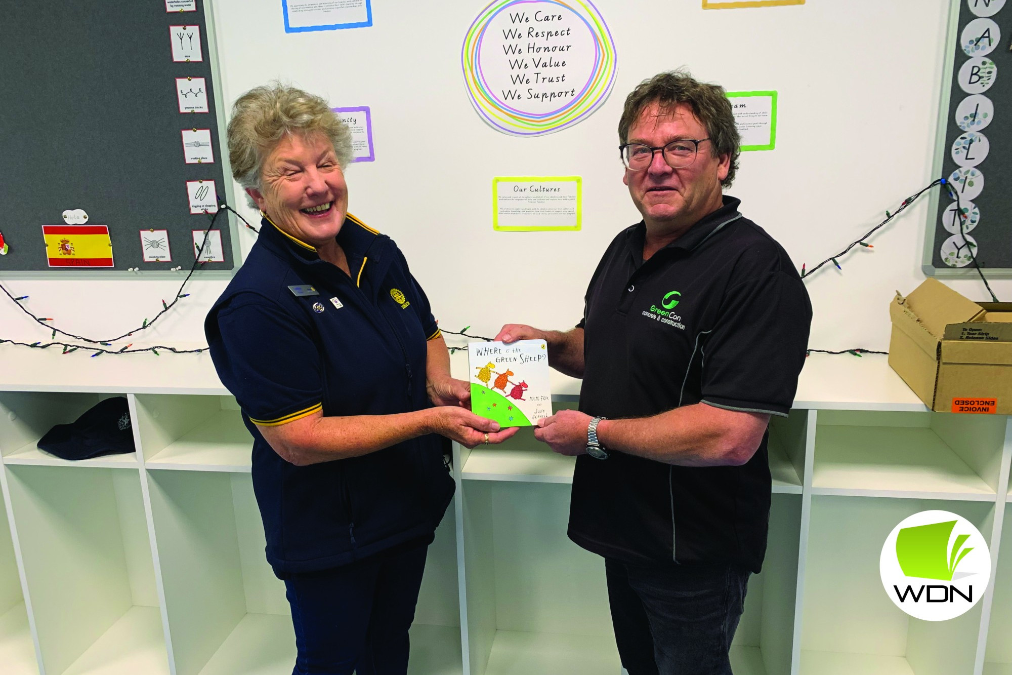 Donation appreciated: Cobden Rotary Club member Lesley Brown accepted a copy of Where is the Green Sheep? from GreenCon managing director James Green.