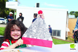 Maddison Jeffries, 5, colours in a santa hat. 