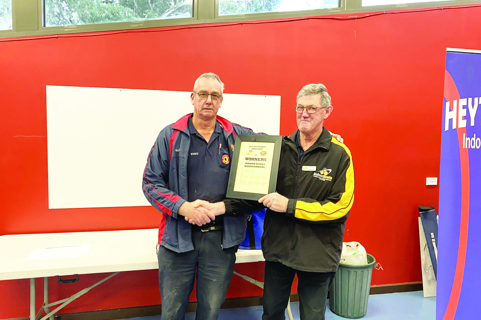 Heytesbury President Max Wines presents Indoor Bowls Warrnambool President Gerald Madden with the overall win.