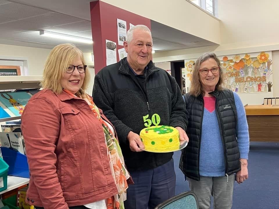 A cake adorned with the school mascot, a dragon, was enjoyed by those in attendance.