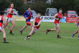 Paul Pekin passes the ball off to Josh Hickey. 