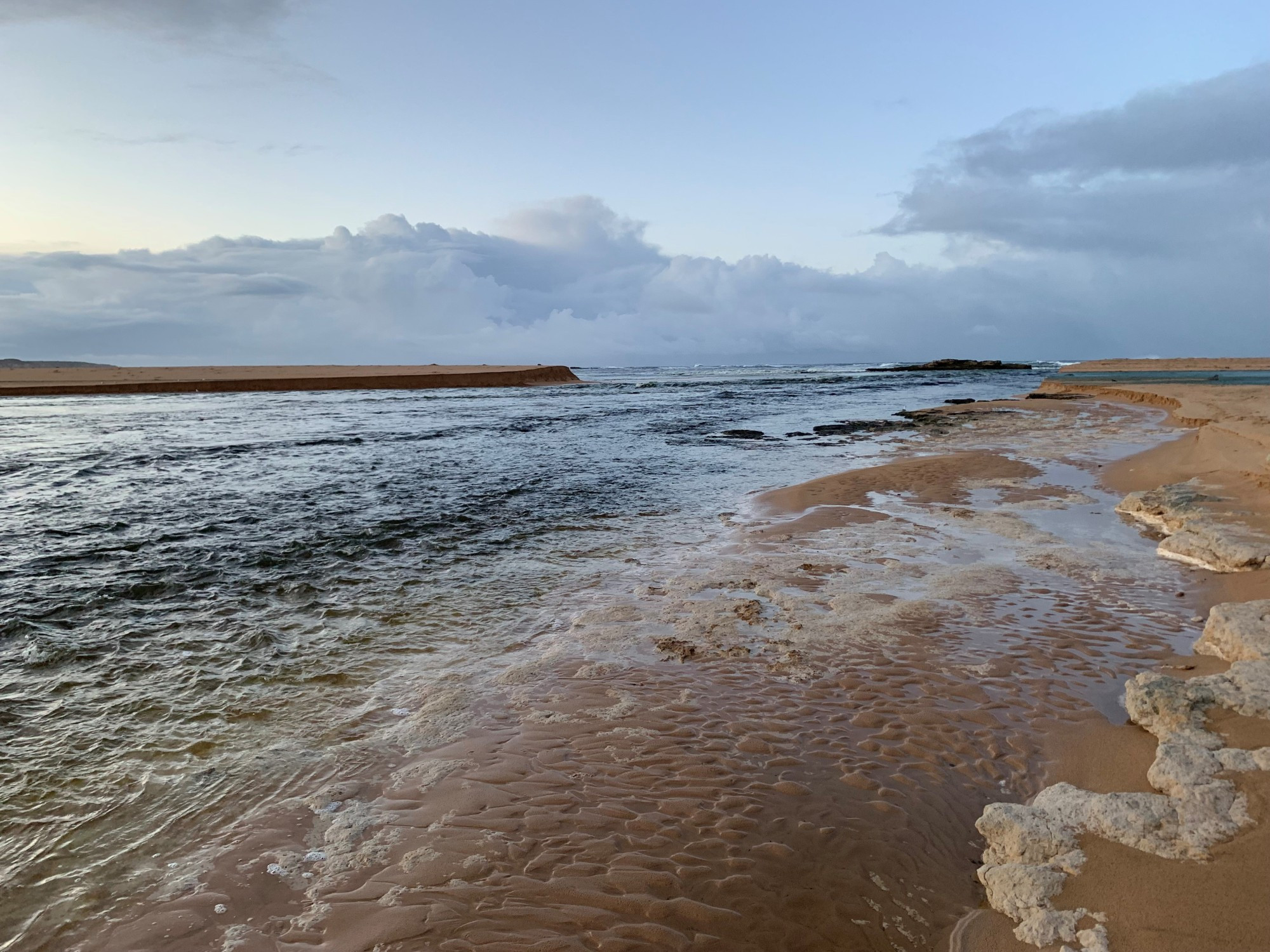 Contractors moved in to artificially open the river mouth at Peterborough after the trigger points were reached. Photo supplied by Parks Victoria