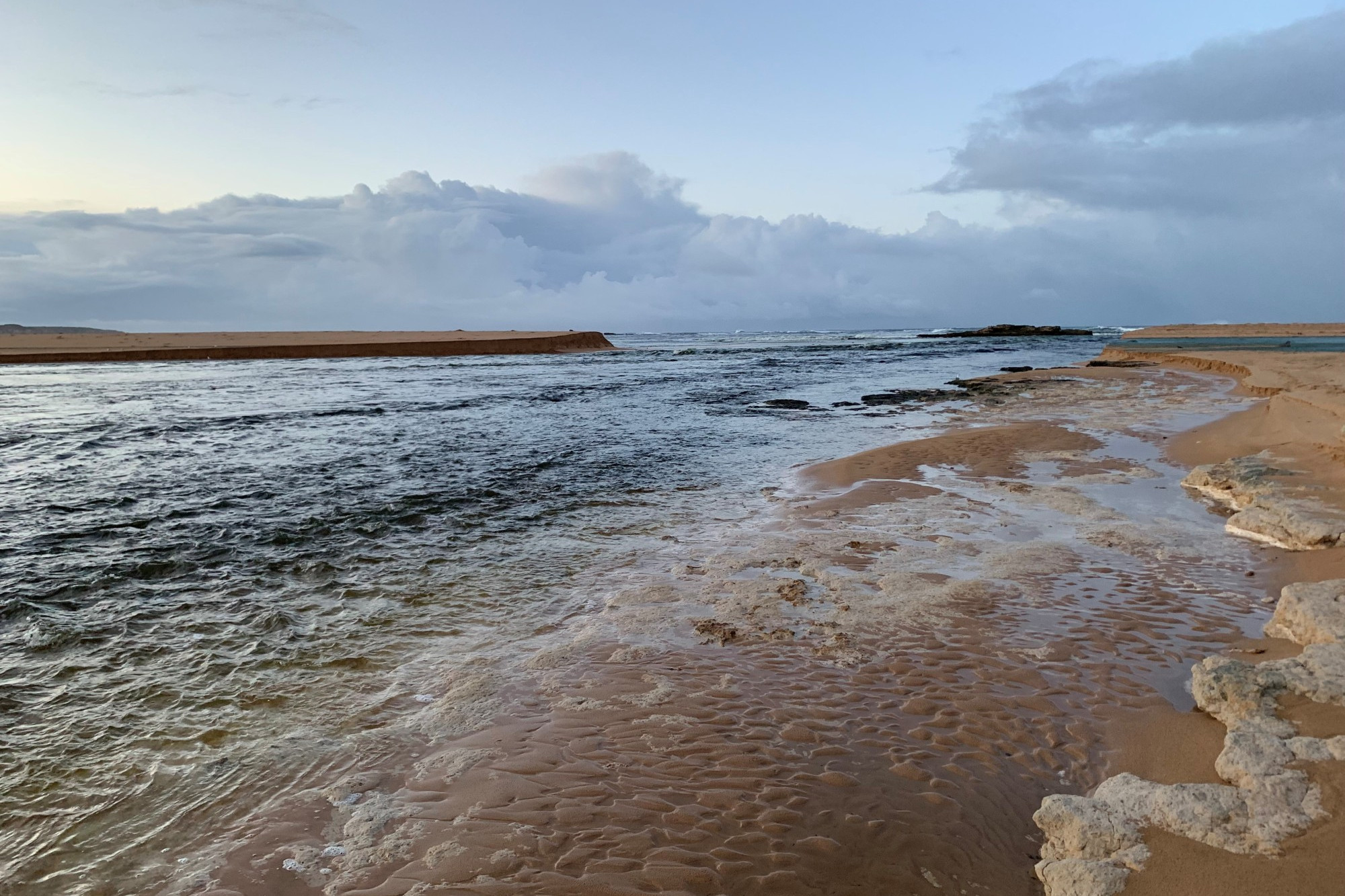 The water flows from the river system into the ocean after being banked up for weeks. Photo supplied by Parks Victoria