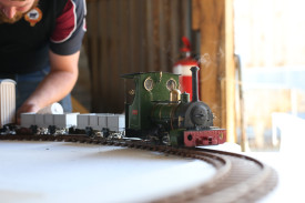 A miniture train goes around the track. 