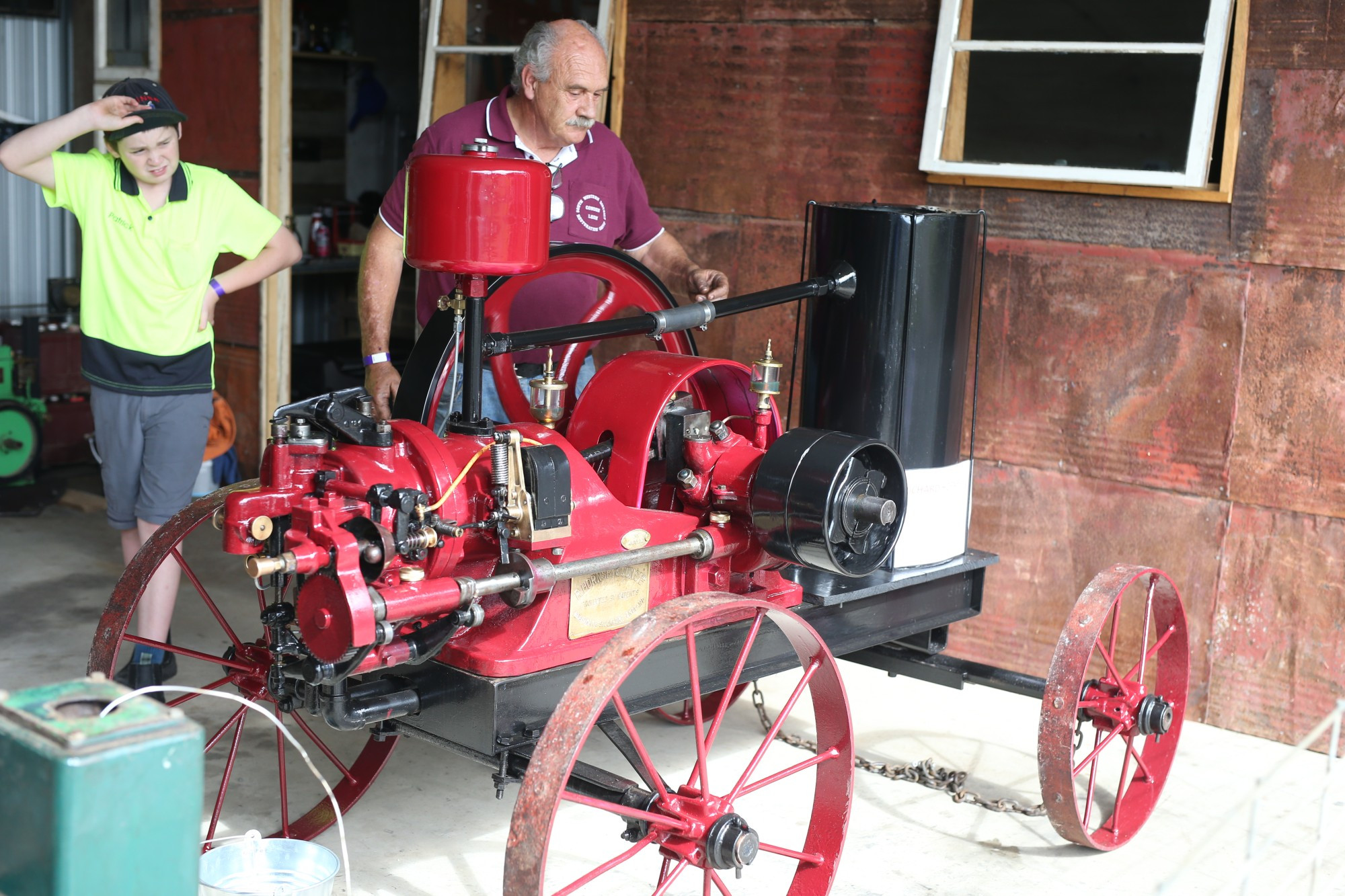 History on show: The South Western District Restoration Group annual rally drew hundreds of people to the area with historical pieces on display. Group member Leon Stuart, with his grandson Patrick, works on a Hornsby oil engine.